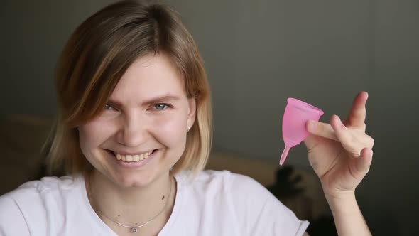 Portrait of Pretty Young Woman Holding Menstrual Cup and Laughing Smiling Iroi