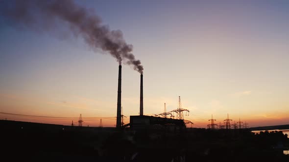 Factory tubes on the sunset background. 