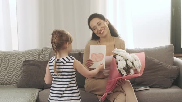 Happy Mother's Day Little Daughter Congratulates Mom and Gives Her Heart Memory Card and White