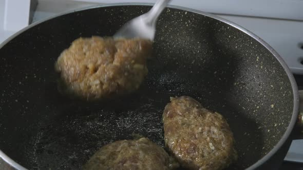 Close-up Turning the Meatballs in the pan