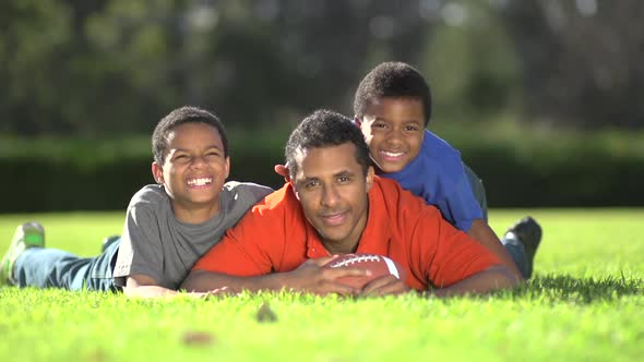 Group portrait of a father and his sons with a football