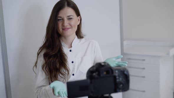 Cheerful Medical Worker Recording Video for Vlog in Front of Camera in Office