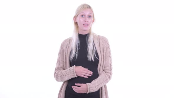 Happy Young Blonde Pregnant Woman Talking To Camera