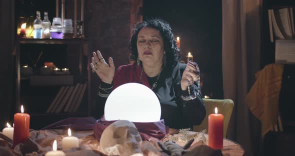 Old Woman Seer Meditating and Predicting Future with Crystal Ball alt