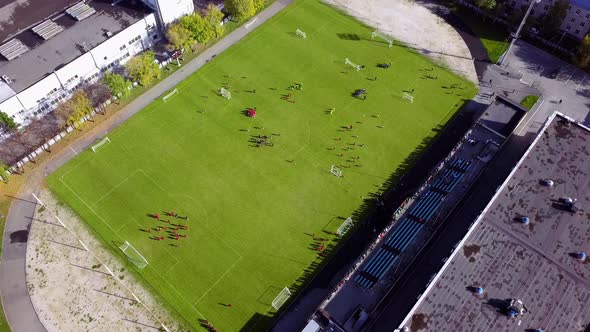 Football Players Running Around The Football Field