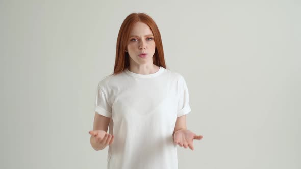 Portrait of Angry Young Woman Talking and Expressive Gesticulating with Hands Looking at Camera