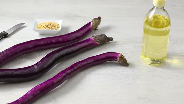  Fresh long thin Japanese purple eggplants close up