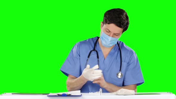 Healthcare Worker Putting on Medical Gloves and Opens Medication. Green Screen