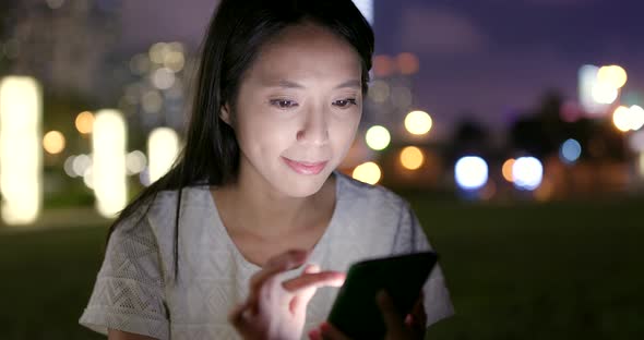 Woman use of mobile phone at night