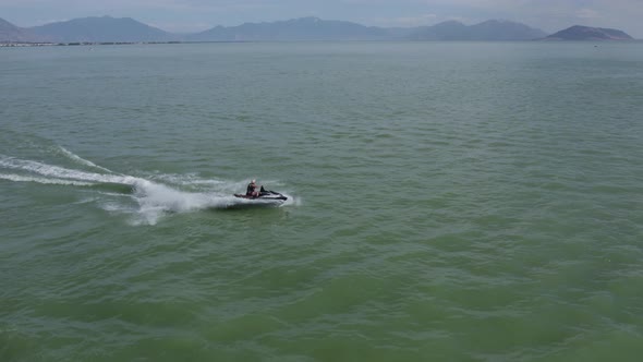 Person having fun with a seadoo on freshwater Utah Lake; aerial view