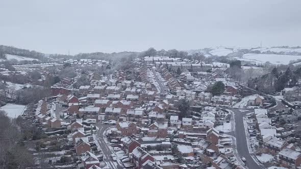 High descending drone shot of snowy Exeter subburbs CROP