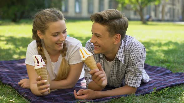 Funny Teens Feeding Each Other With Ice-Cream