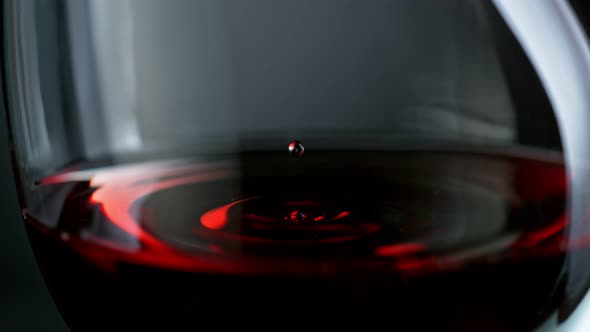 Super Slow Motion Macro Shot of Wine Drop Falling Into Red Wine in Glass at 1000Fps