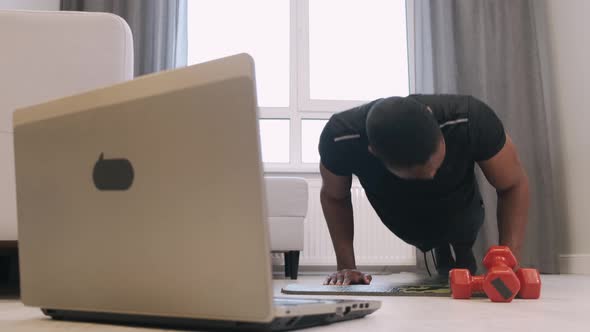 Determined Male Fit Sportsman Exercising at Home