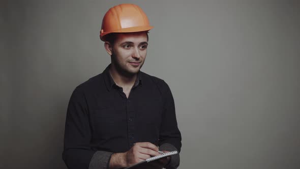 Young Man Architect in Building Helmet