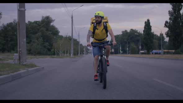 Bicycle Messenger Cycling on a Road