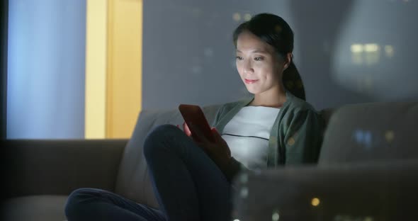 Woman look at mobile phone at home