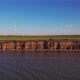 Windmills on a cliff above the sea, top view. Wind farm with turbine cables for wind energy. - VideoHive Item for Sale