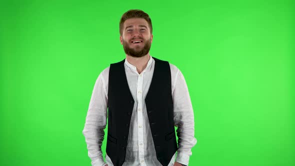 Man Laughs While Looking at Camera. Green Screen