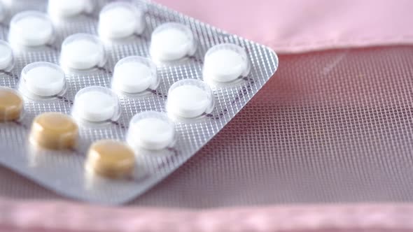 Birth Control Pills on Wooden Background Close Up