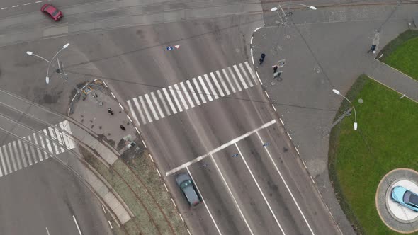 Cars Move Through Crosswalk Near Large Intersection in the City - Drone Overhead Zoom-in Shot.