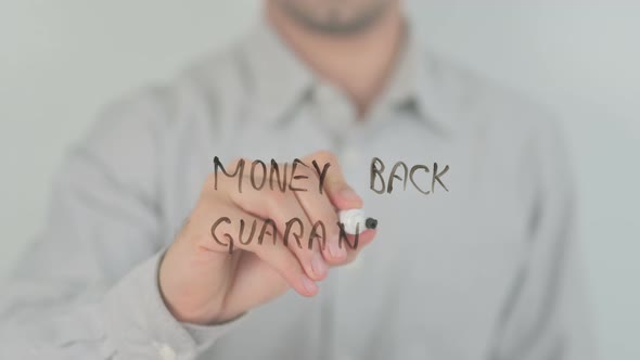 Money Back Guarantee Writing on Screen with Hand