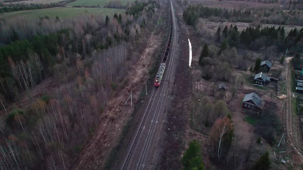 A Train with Empty Open Hoppers Passes By the Village