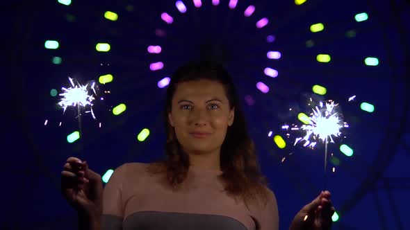 An Attractive Girl is Happy with a Holiday with Fireworks in Her Hands