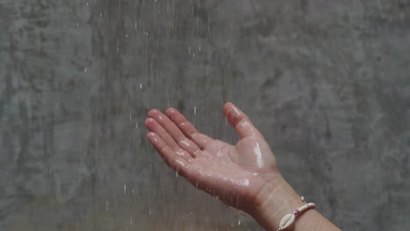 Water Pouring From Shower on Hand