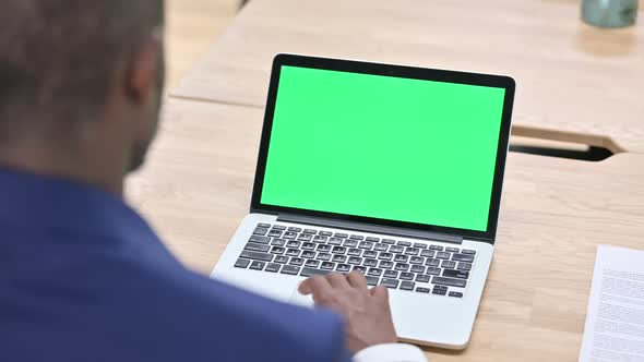 African Man Scrolling Laptop with Chroma Screen