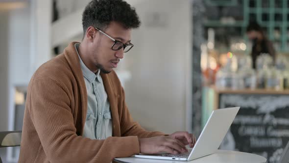 African Man Working Laptop Cafe