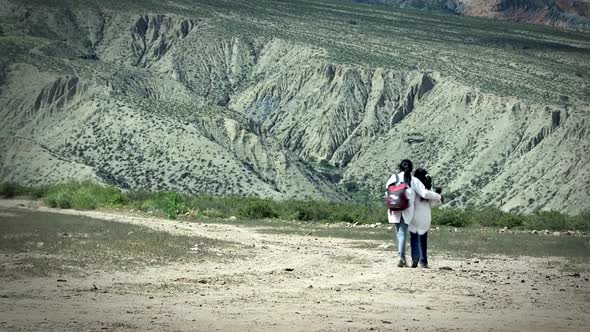 Two Argentine Elementary School Students Walking Towards the Andes Mountains.