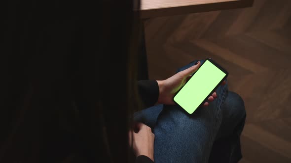 Back View of Woman Holding Smartphone Chromakey Green Screen Watching Content Has Video Call