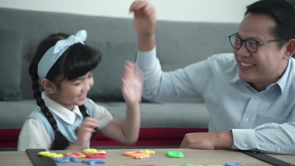 happy family at home, daughters with parents playing toy, playing to create learning of children