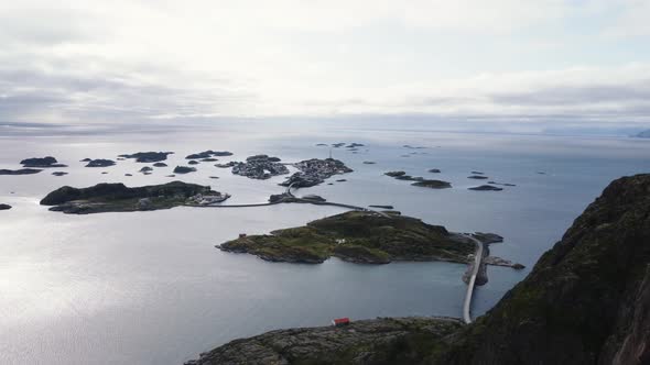 Overlooking the ocean and all the connected islands of Henningsvaer with the sun breaking through th