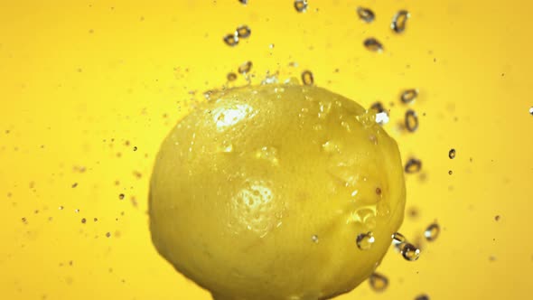 Flying of Lemon in Yellow Background in Slow Motion