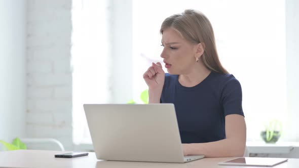 Woman Coughing While Using Laptop