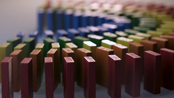 Line up of Dominoes in Rainbow Falling Colors with LGBT Colors of a Hand