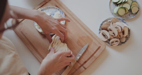 Close-up of woman preparing ingredients for homemade pizza