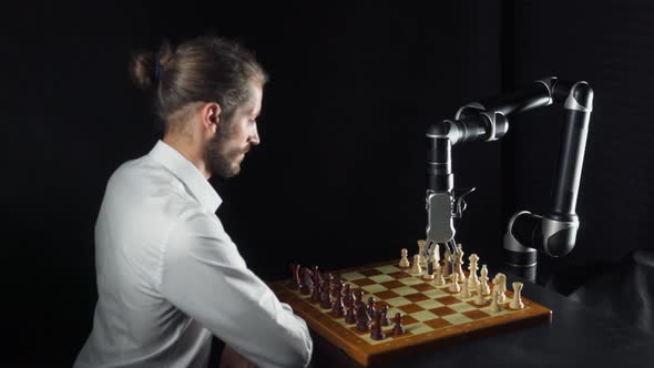 Modern Technology, Man Playing Chess with a Robot, the Confrontation Between Man and Artificial