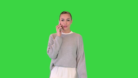 Stylish Casual Girl Walking and Calling on a Green Screen Chroma Key