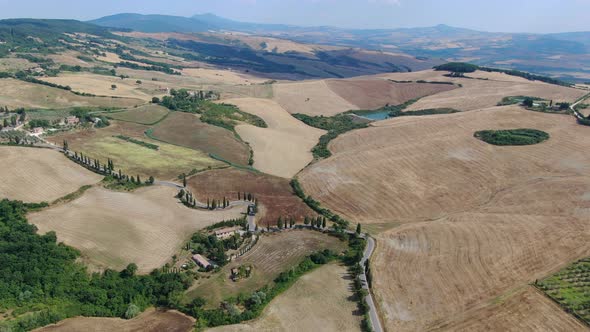 Flying over famous winding road lined by cypress trees in Tuscany, Italy, Europe