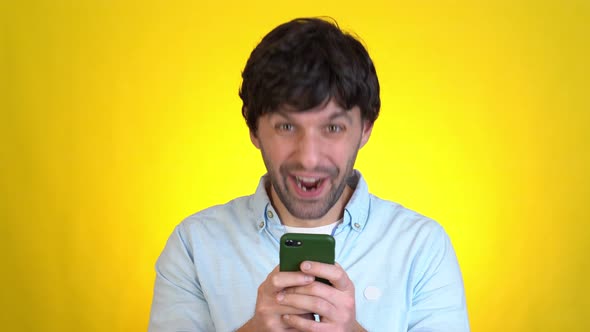 Handsome Unshaven Young Guy Isolated on Yellow Background in Studio