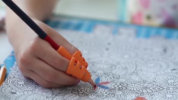 Close-up hand of a child holding a pencil