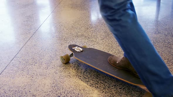 Executive skateboarding in office