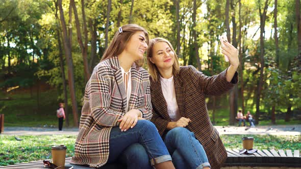 Bloggers using smartphone for live streaming in park