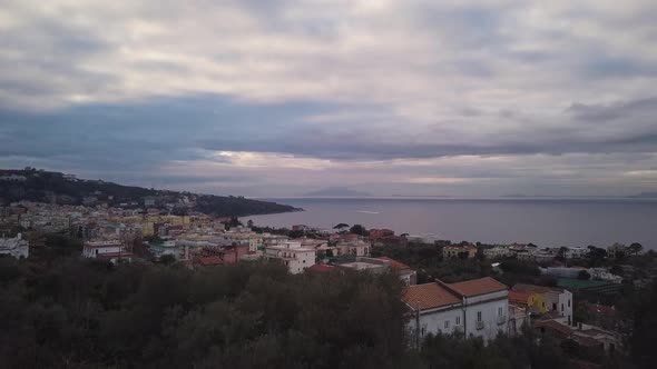 Drone reveal shot of the coastal town of Sorrento in Italy, a beautiful landscape of houses near the