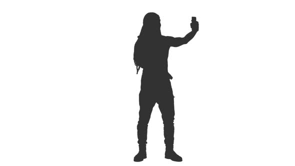 Silhouette of Male Tourist in Arabic Scarf Taking Selfie