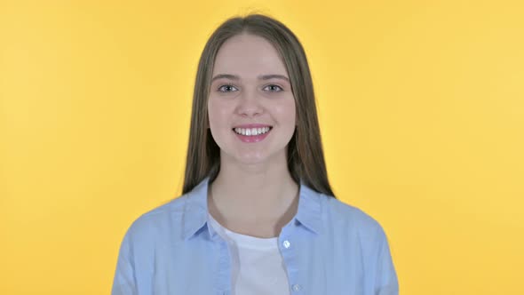 Portrait of Smiling Casual Young Woman, Yellow Background