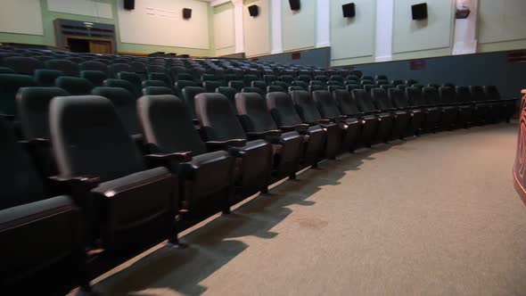 Motion Past Rows of Chairs in Spacious Empty Auditorium